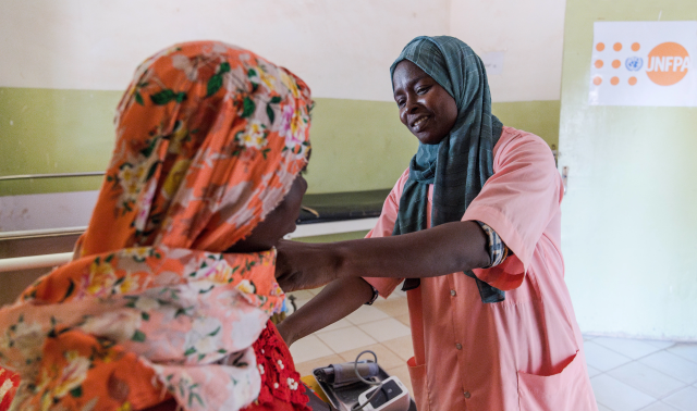 A midwife helping a patient