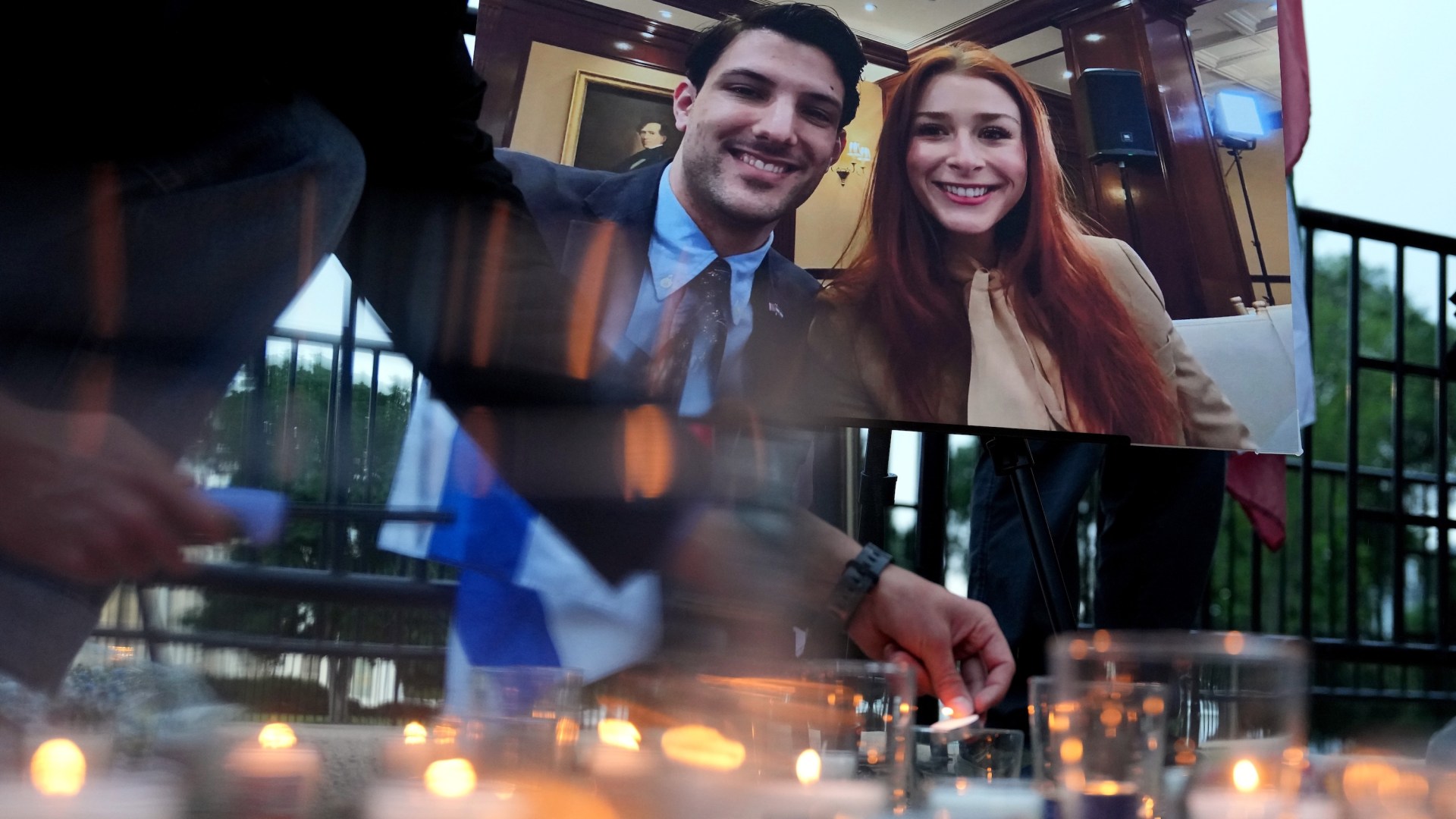 Mourners light candles during a May 22 vigil for the victims of the Capital Jewish Museum shooting, Israeli embassy staffers Yaron Lischinsky and Sarah Lynn Milgrim.