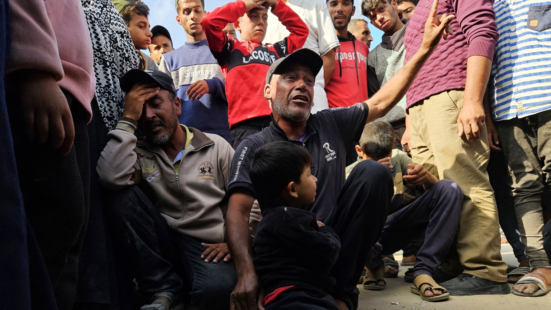 Relatives mourn after Israeli soldiers opened fire and killed Palestinians trying to reach US aid in Rafah.